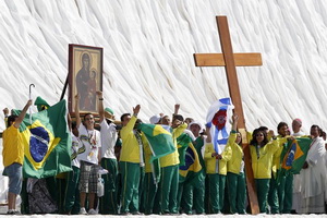 Brazilian pilgrims lift the World Youth Day cross at the Cuatro Vientos aerodrome in Madrid